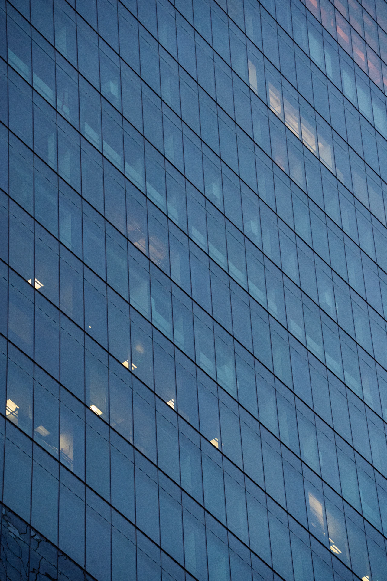 Glass facade of a modern office building at dusk