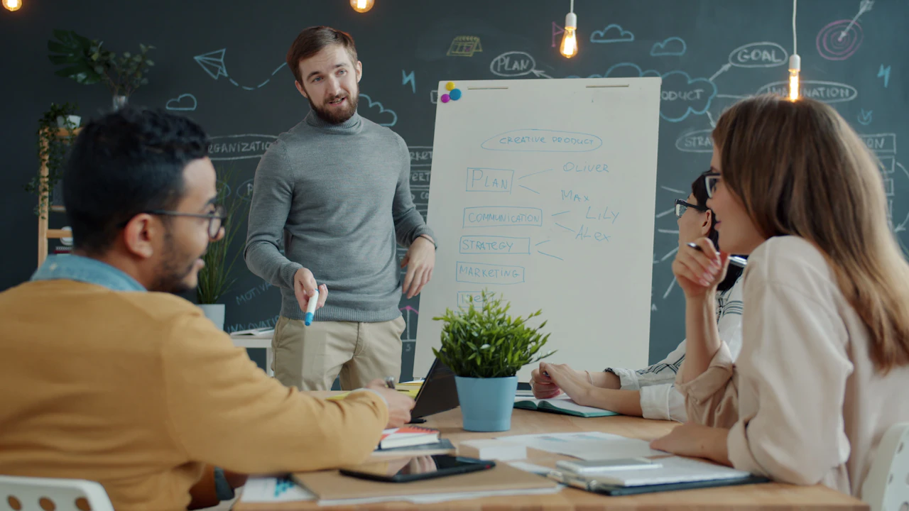A team discussing strategy around a whiteboard in a modern office